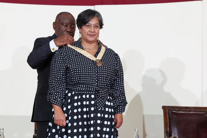 Prof. Priscilla Baker receiving her National Order of  Mapungubwe Bronze medal from pres. Cyril Ramaphosa.