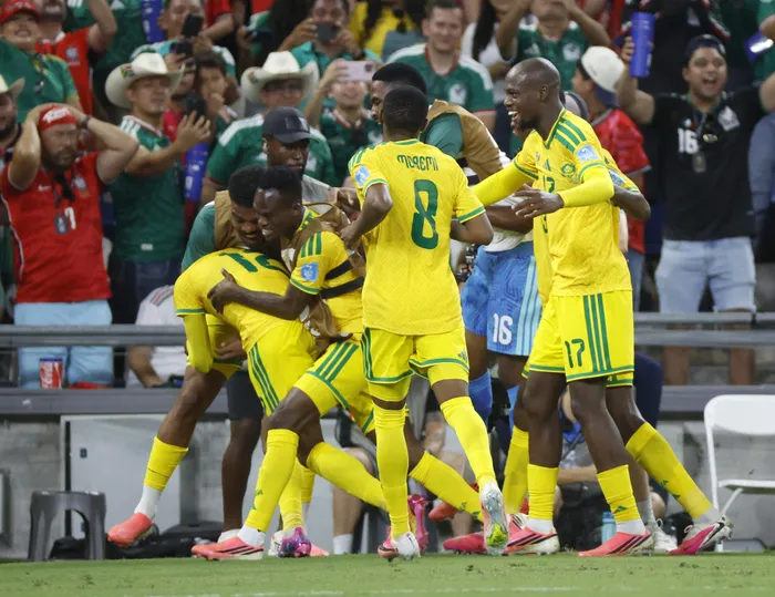 Thapelo Maseko celebrates with teammates after scoring the winner against South Korea, sending Bafana Bafana into the World Cup knockout stages for the very first time. 
