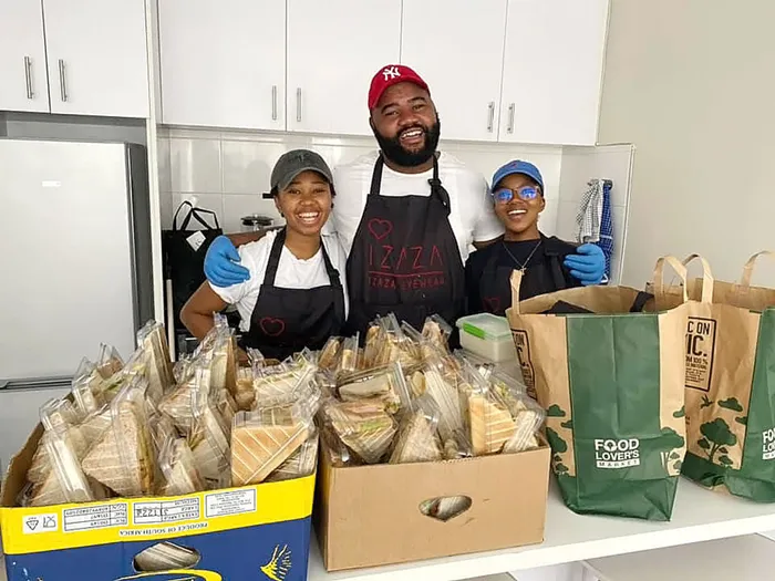 The co-owner of Estratweni Mobile Foods, Thando Mavumengwana (centre) and his colleagues Thimna Mdloyi (left) Nonkoliseko Somagu (right) distributed sandwiches to job hunters and school children in the CBD. Mavumengwana said they were inspired by their recollections of when they would go long days without having something to eat while queuing to get their small business registered in the CBD.