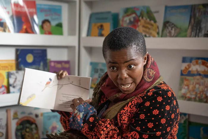 Local singer Zolani Mahola reading to children at a preschool in Samora Machel. Picture: Supplied