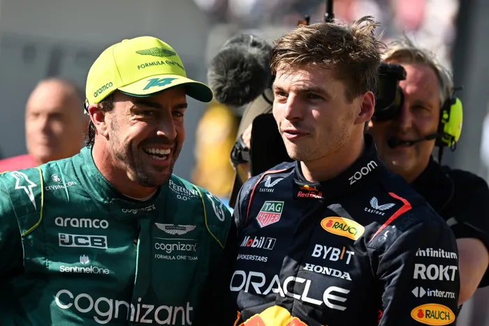 Pole position winner Red Bull Racing's Max Verstappen and grid second-placed Aston Martin's Fernando Alonso react after the qualifying sessions of the Formula One Monaco Grand Prix at the Monaco street circuit in Monaco, on Saturday