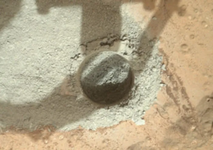 Nasa rover drills into Martian rock