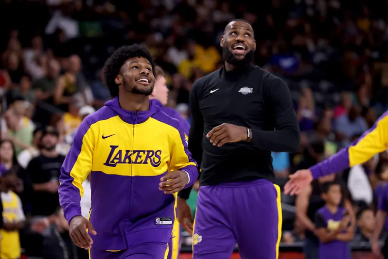 Bronny James and LeBron James of the Los Angeles Lakers warm up prior to their game against the Phoenix Suns