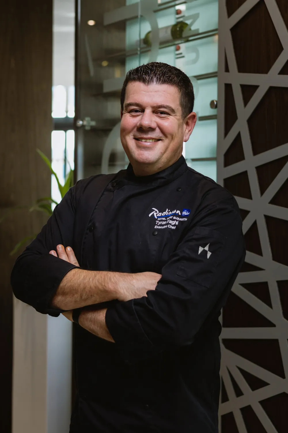 Radisson Blu executive chef Tyran Vaghi in black chef’s coat.
