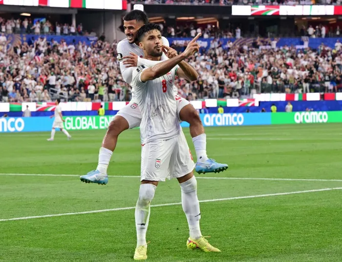 Iran's midfielders Mohammad Mohebbi, front, and Mehdi Ghayedi, back, celebrate one of their goals in their 2026 Fifa World Cup clash against New Zealand in Los Angeles Stadium.