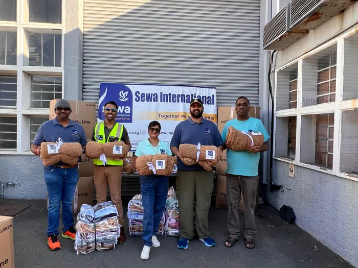Volunteers from Sewa International South Africa sorting through blankets as part of their Winter Warmth Blanket Drive
