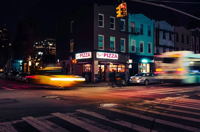 Grab a slice of thin-crust pizza at Joe's Pizza on Carmine Street.