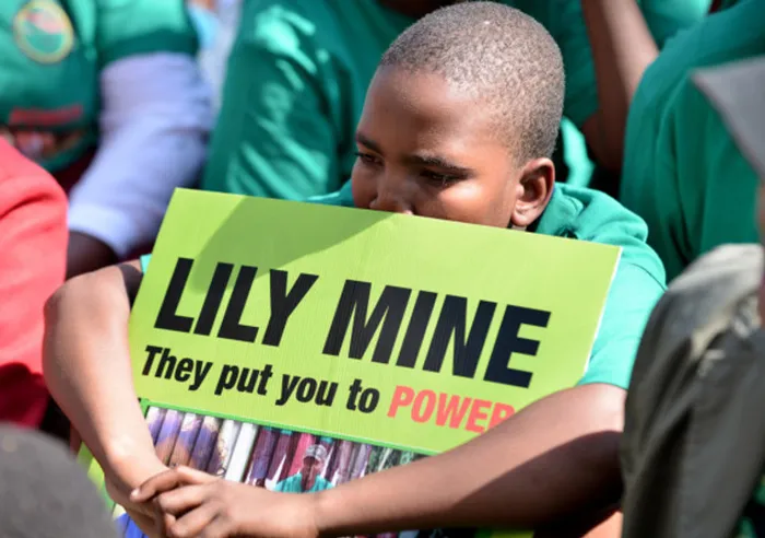 A young protester shows solidarity with the families of Lily Mine workers who were trapped in a container underground. Picture: Phill Magakoe