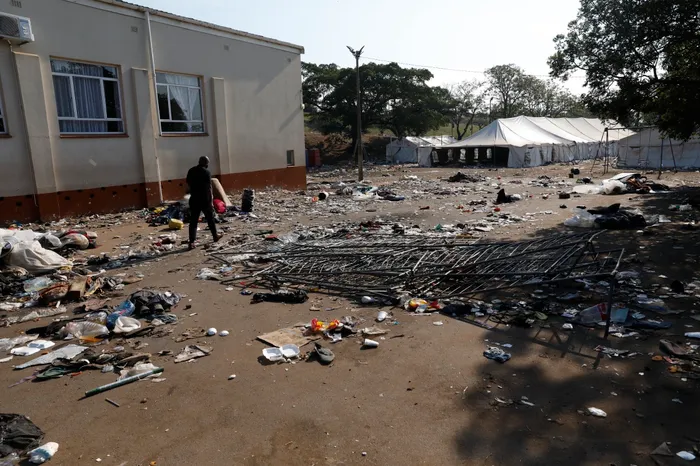 Officials observe the aftermath during the cleanup.