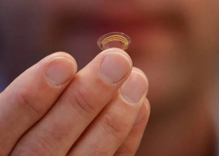 Brian Otis, Google X project lead, holds a contact lens Google is testing to explore tear glucose. Picture: AP Photo/Jeff Chiu