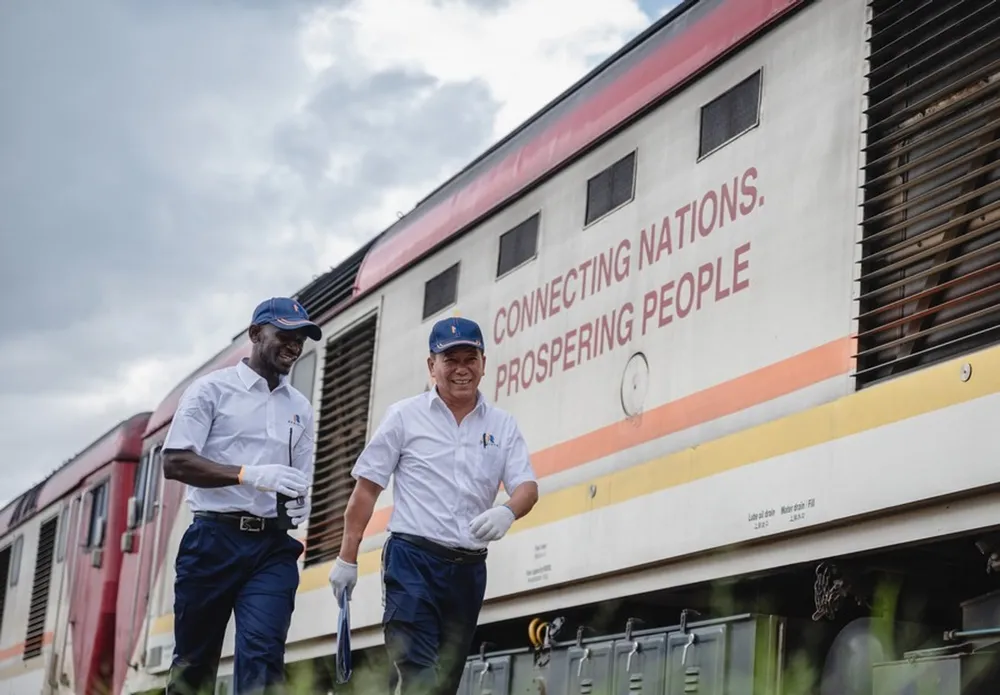Chinese instructor Jiang Liping and apprentice Horace Owiti walk past a train carriage on the Mombasa-Nairobi Railway in Nairobi, Kenya, May 23, 2023. Xinhua/Wang Guansen