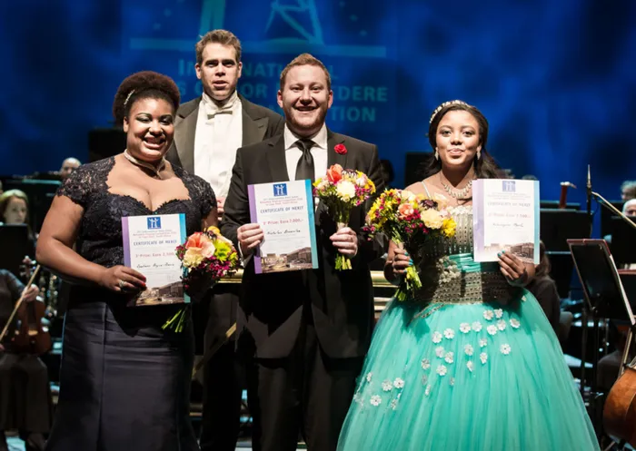 OUTSTANDING: From left, Raehann Bryce-Davis won 3rd Prize, Nicholas Brownlee (took 1st Prize), Noluvuyiso Mpofu (won 2nd Prize plus the Audience Prize). At the back is Conductor Kamal Khan of The Cape Town Philharmonic Orchestra. Picture: KIM STEVENS