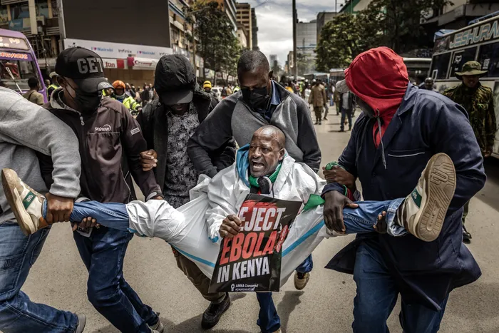 An activist shouts slogans while being arrested by plainclothed Kenyan police officers during a protest against a US-built Ebola quarantine centre planned to begin operations at Kenya's Laikipia Air Base, in downtown Nairobi on Tuesday. Kenya's president defended the opening of an Ebola quarantine centre for US nationals after a court halted the plan and security forces teargassed protesters fearing the deadly virus could spread in the country.