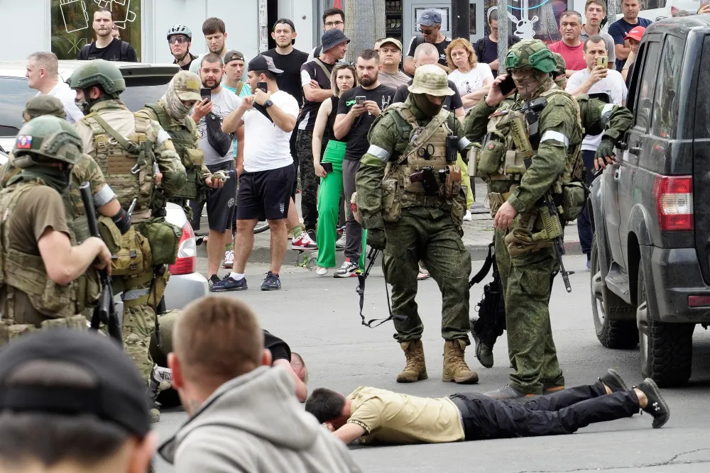 Members of the Wagner group detain a man in the city of Rostov-on-Don, on June 24, 2023, after they took control of the city. Picture: AFP