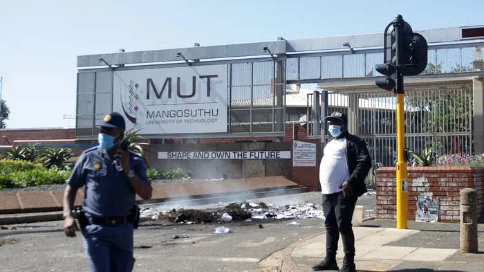 Police officers cleaning Mangosuthu Highway after the student's protest in uMlazi, earlier this year. Picture: Bongani Mbatha /African News Agency (ANA)