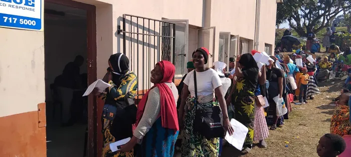 Displaced Malawian women queue outside the Sherwood Hall in Durban waiting to be processed by Department of Home Affairs officials. 