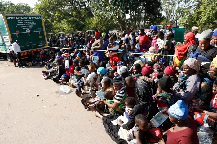 Women and children of Malawian immigrants wait anxiously at Sherwood Hall.