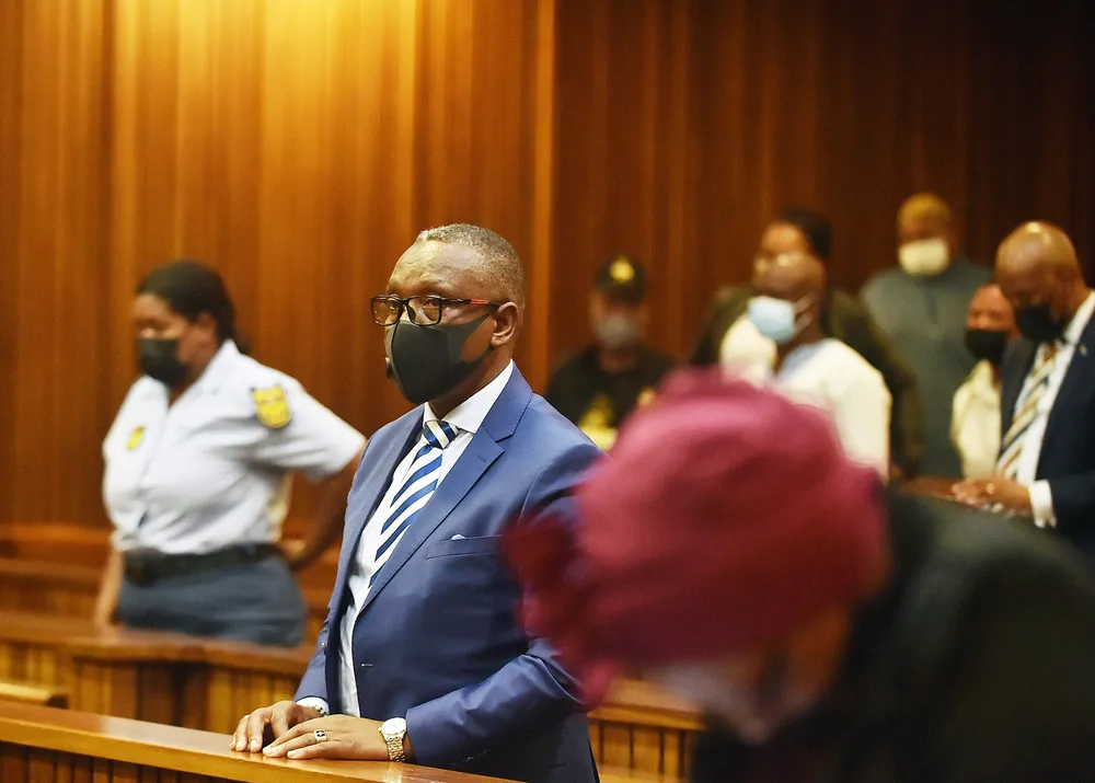 Man stands in a courtroom.