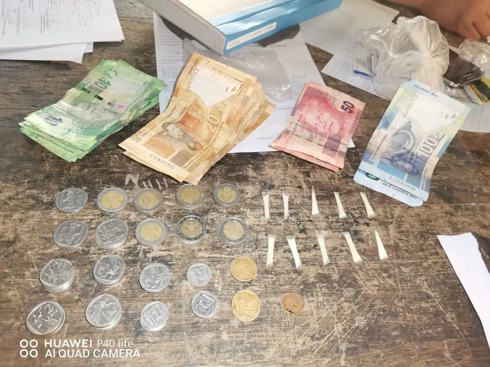 Stacks of notes and coins on a table.