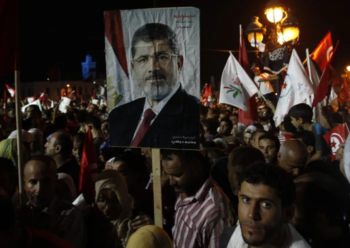 Supporters of the Islamist Ennahda movement hold a portrait of ousted Egyptian President Mohamed Morsi during a demonstration at Kasbah Square in Tunis.