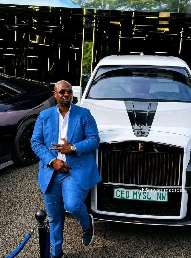 Solly Soka Madibela popularly known as MySol with his Rolls Royce at his R220 million mansion in Cape Town. The writer argues that South Africa has developed a harmful tendency to treat black success with suspicion instead of pride. While corruption must be confronted, the article warns against automatically associating black wealth and achievement with criminality, saying such attitudes reflect lingering colonial thinking that undermines true economic transformation and black excellence.