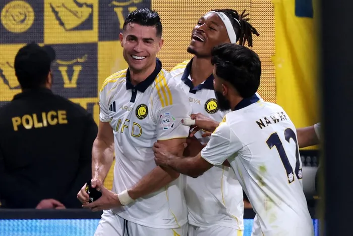 Nassr's Portuguese forward Cristiano Ronaldo (L) celebrates with teammates after winning the Saudi Pro League title at the end of their football match against Damac at the Al-Awwal Park Stadium in Riyadh on May 21, 2026. Picture: Fayez NURELDINE / AFP