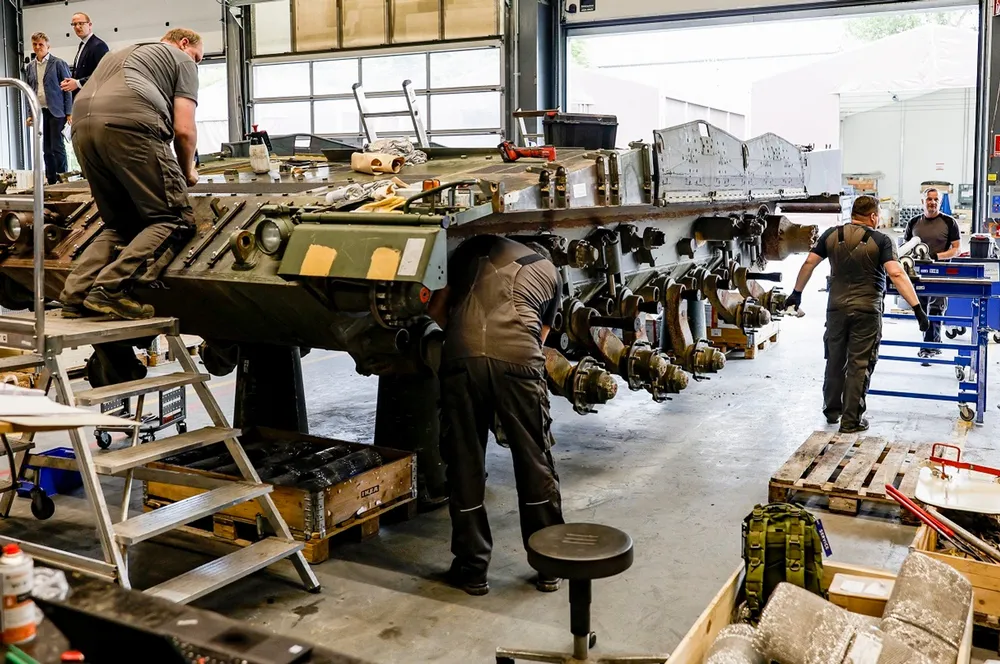 Technicians of German armaments company and automotive supplier Rheinmetall assemble a Leopard 2A4 battle tank that gets maintenance at the facility of Rheinmetall in Unterluess, northern Germany, on June 6, 2023. Rheinmetall has received a boost from the Ukraine war, posting record results in 2022. Picture: Axel Heimken / AFP