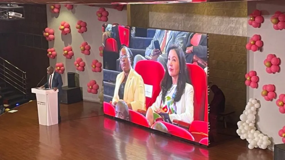 A woman presents on stage while China’s Twinkle Star launch images play on the big screen.