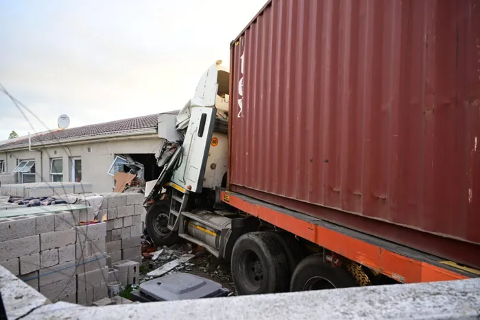 A container truck collided with a house in Bothasig, leaving one person injured and the occupants shaken but unharmed.