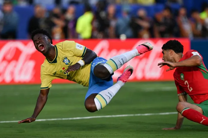 Brazil's forward Vinicius Junior reacts after being tackled late by Morocco's Achraf Hakimi in the 2026 World Cup Group C football match between Brazil and Morocco at the New York/New Jersey Stadium in East Rutherford on June 13, 2026. 