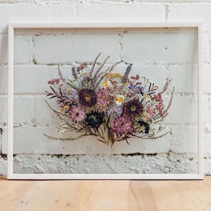 Your whole bouquet can be pressed and dried and then framed between two pieces of glass, creating a stunning and sentimental piece of wall art. Picture: Pinterest