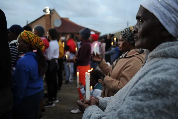 The candle lighting ceremony in memory of the #EnyobeniTavern tragedy where 21 pupils from local schools perished almost two weeks ago is in motion outside the establishment at Scenery Park, East London. Photo: Henk Kruger/African News Agency