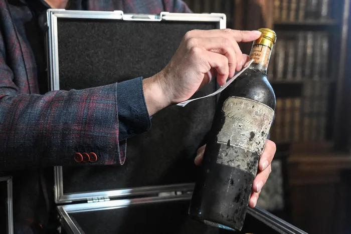 One of five restored bottles by iconic French wine house Château d'Yquem from the 19th-century is presented at the Becov castle this week in the village of Becov nad Teplou, Czech Republic. Eight bottles of a legendary French wine that survived World War II and decades of communist rule hidden under a Czech castle floor have been restored by the chateau that produced them some 130 years ago.