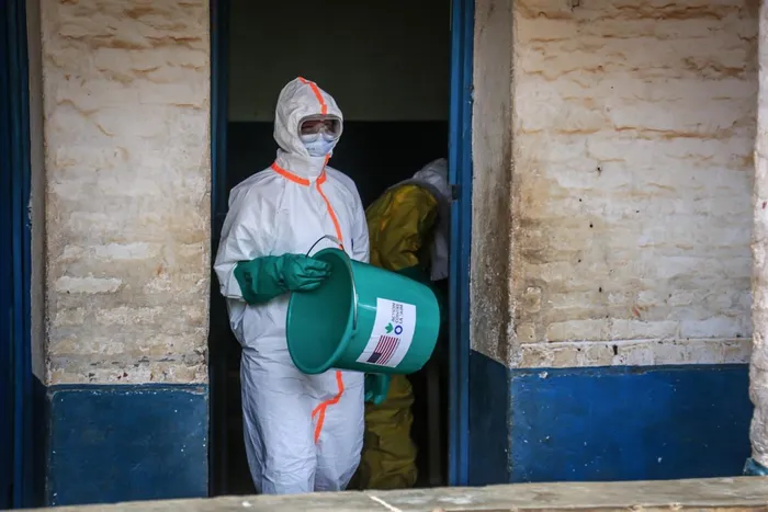 A health worker wearing protective equipment disinfects the isolation area for Ebola patients at the General Referral Hospital of Mongbwalu in Mongbwalu, on May 23, 2026.