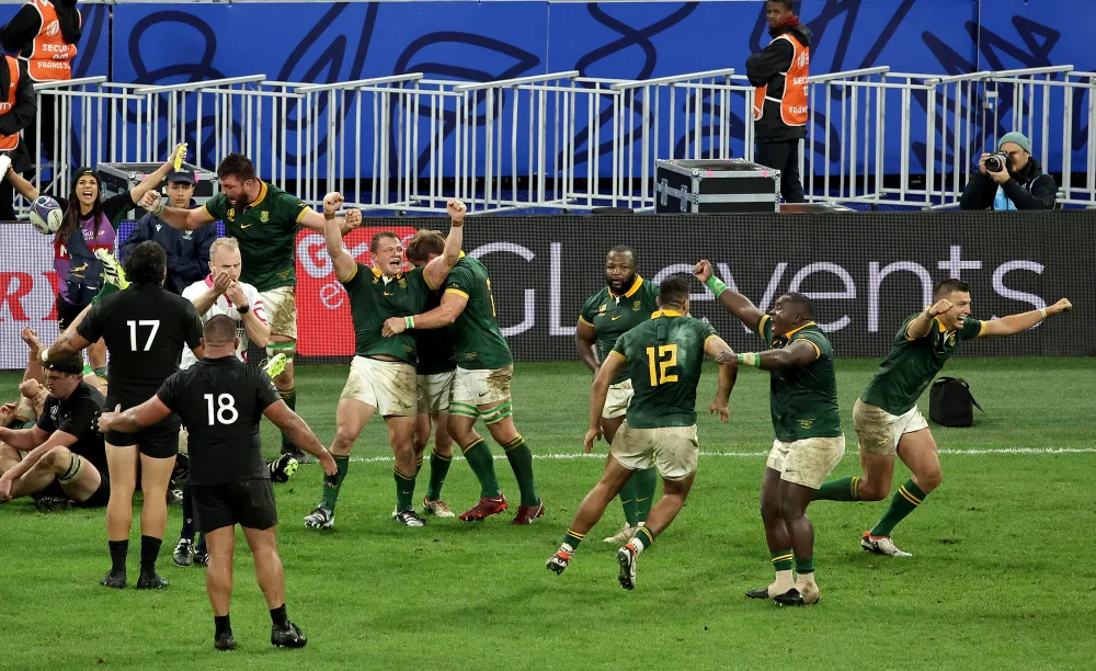 Springbok players celebrate as the final whistle blows during the Rugby World Cup final against New Zealand at Stade de France in Paris on Saturday