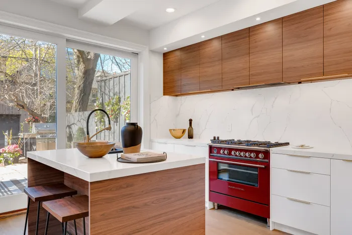 Changing out cabinet fronts is an investment, but it's a worthy one; pick classic wood finishes, such as walnut, and stay away from yellow or pink-red stained wood, which can look dated, designer Kelly Emerson says. Picture: André François McKenzie/Unsplash