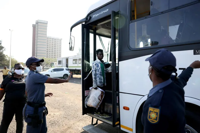Immigrants boarding buses at the Durban drive-in site, part of a large-scale repatriation initiative.