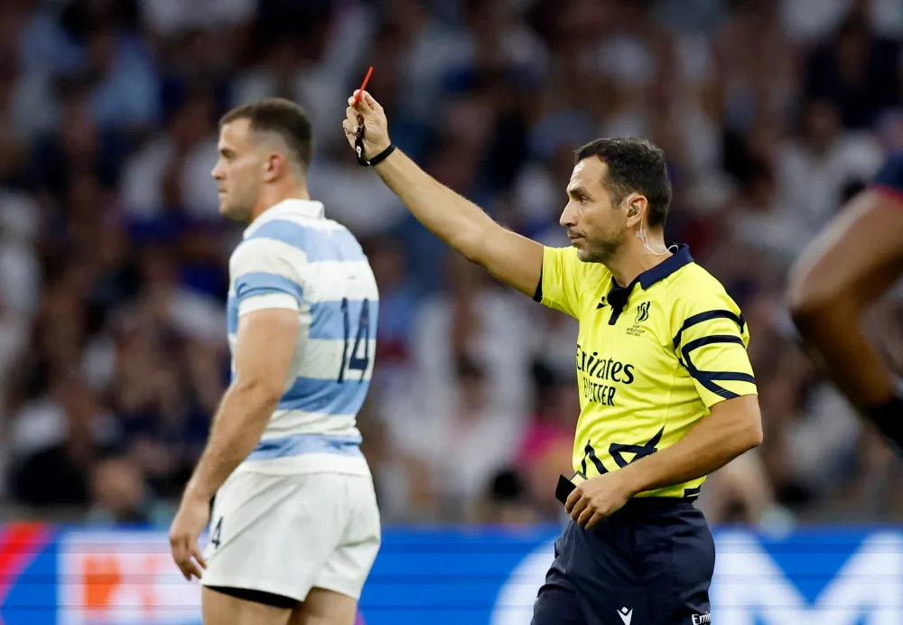 Referee Mathieu Raynal shows a red card to England's Tom Curry after a TMO review during the Rugby World Cup match between England and Argentina in Marseille