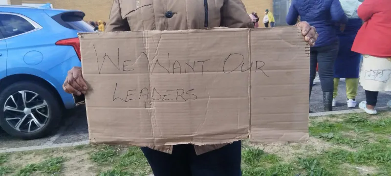 Community protests for leaders facing arson charges in Covid settlement