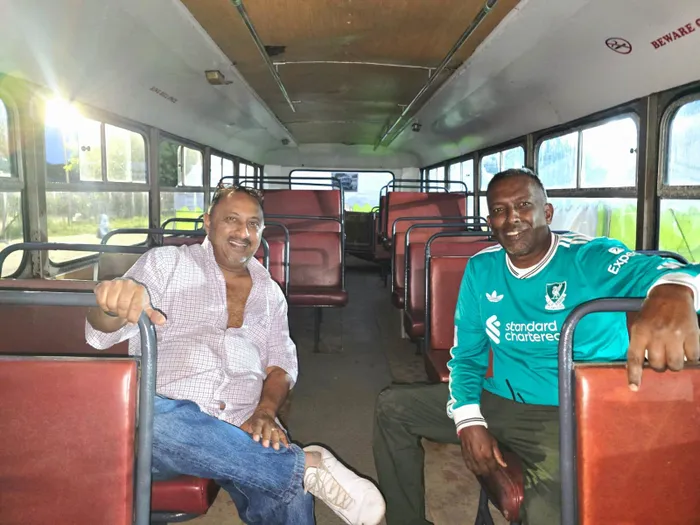 Signwriters Jeenesh Udit, left, and Roshan Mewlal inside the Leyland OPS bus. They still give the buses a stylish look. 