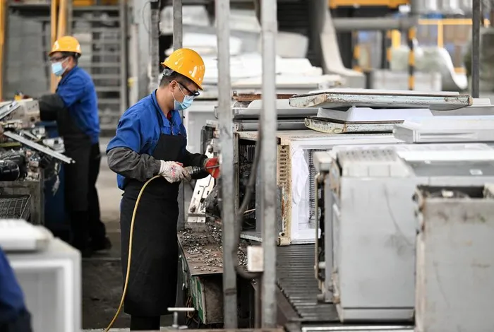 A staff member dismantles discarded refrigerators at a circular economy industrial park of the Tianjin Ziya Economic and Technological Development Area in Tianjin, north China, October 22, 2024.