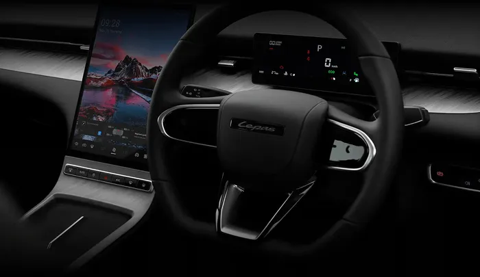 The dashboard is dominated by a large 13.2-inch portrait-style infotainment screen and a clean centre console.