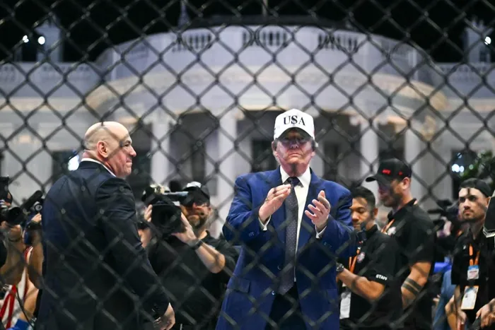 US President Donald Trump stands in The Octagon with UFC CEO Dana White at the conclusion of the "UFC Freedom 250" mixed martial arts event on the South Lawn of the White House in Washington, DC, in the early morning hours of June 15, 2026. 