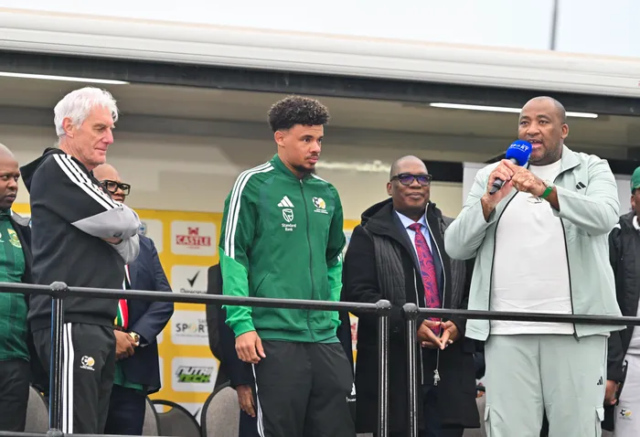 Bafana Bafana coach Hugo Broos, Rowen Williams and Gauteng Premier Panyaza Lesufi listen attentively as Minister of Sport Gayton McKenzie welcomes the team at OR Tambo Airport on 2 July.