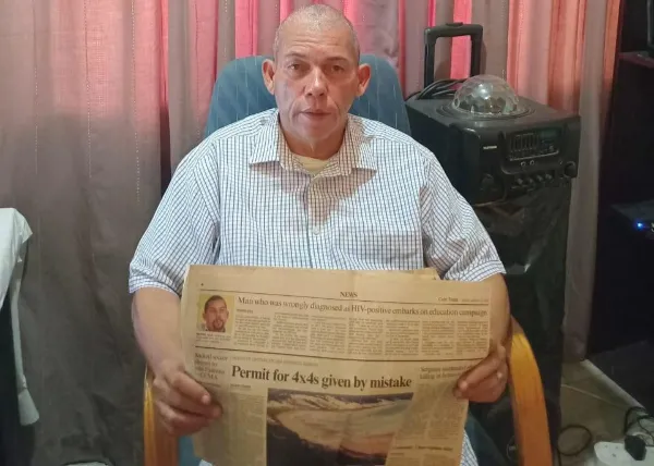 20 years later, Mark Johannes holds the Cape Times that first told his story in 2007.