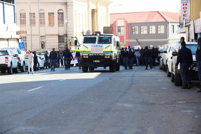 Police officers and other law enforcement agencies monitor anti-illegal immigration protests as demonstrators march on Tuesday.