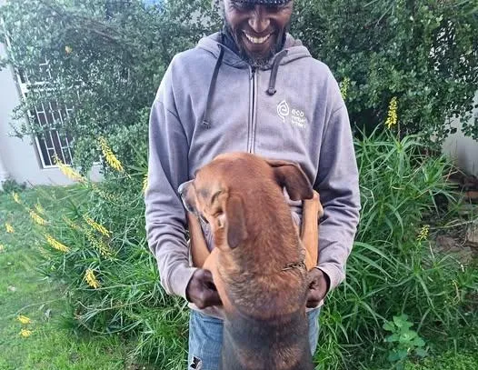 Stephen Singhini with Fireman, the dog he will be  reunited with in Malawi after being forced to leave South Africa.