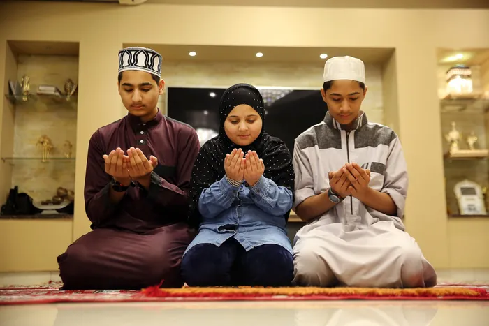 A Muslim family offering prayers during Eid al-Fitr in Durban. Picture: Motshwari Mofokeng/African News Agency (ANA)