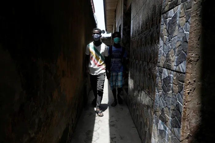 Kehinde, 28, an entertainer who is visually impaired, walks through the corridor at his church with assistance from his friend in Lagos