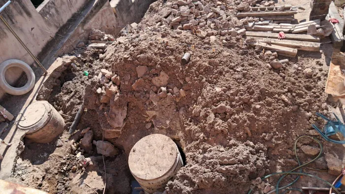 Samantha Kuppan's yard with the exposed manhole. 